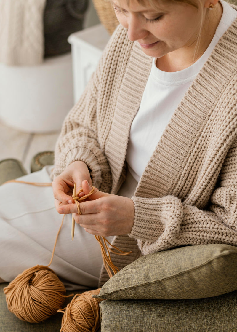 Woman knitting with Mary Maxim yarn
