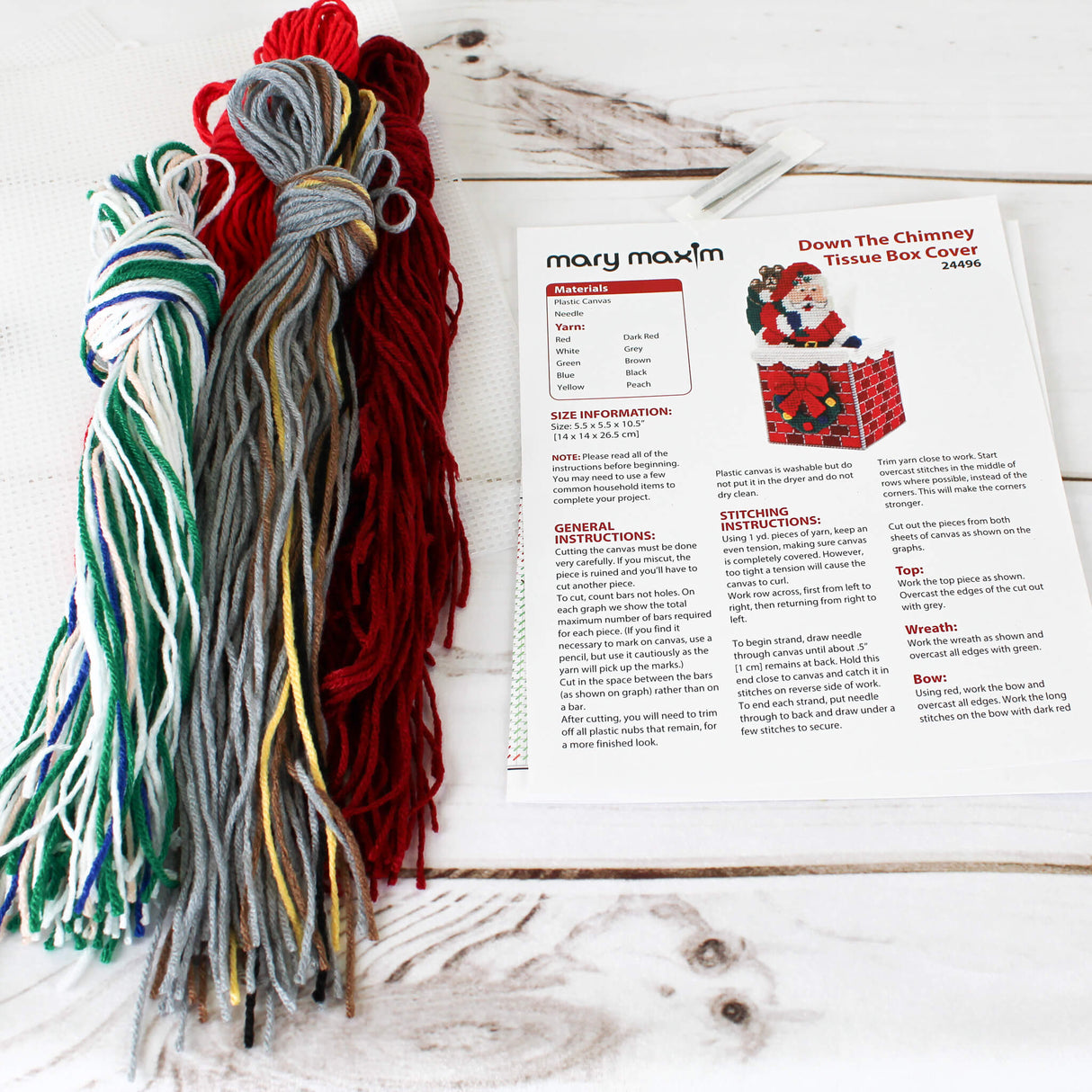 Plastic Canvas Down the Chimney Tissue Box Cover featuring Santa with Presents going down a brick chimney