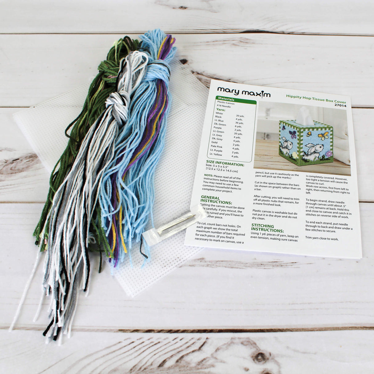 Plastic Canvas Tissue Box Cover blue and grass green with a bunny sniffing flowers and a yellow or purple butterfly.