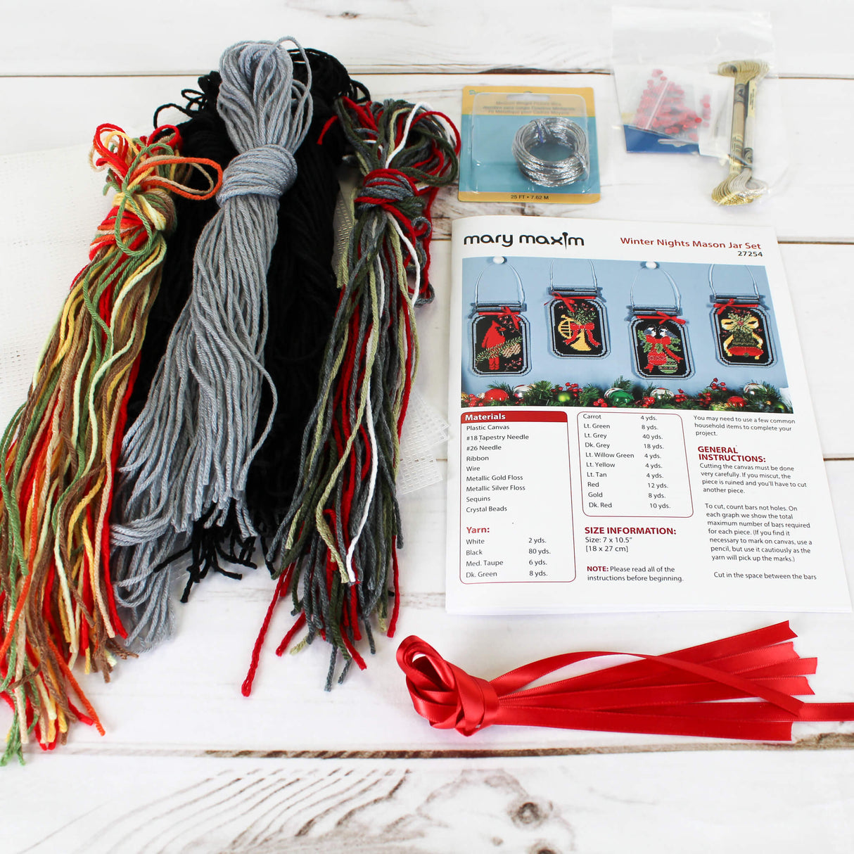 Plastic Canvas home decor wall hanging 4 mason jars featuring a cardinal, trumpet, bell, and ornament on a black background.