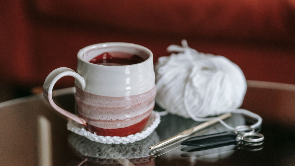 White mug on a crocheted coaster